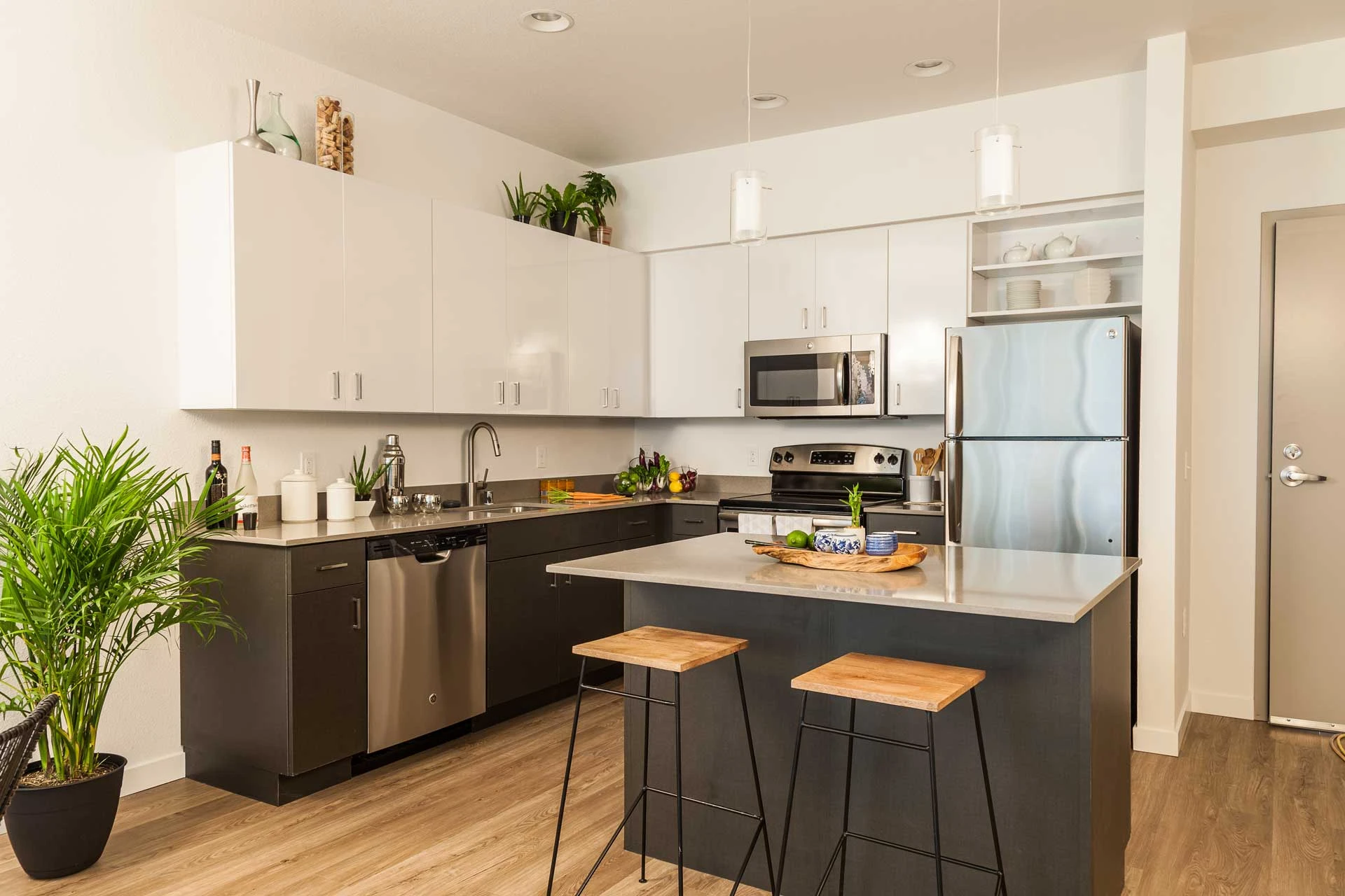 A kitchen with a center island with two stools.
