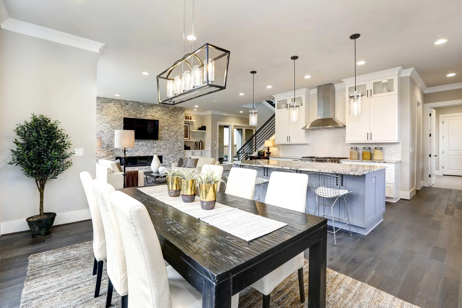 A dining room table with chairs and a chandelier.
