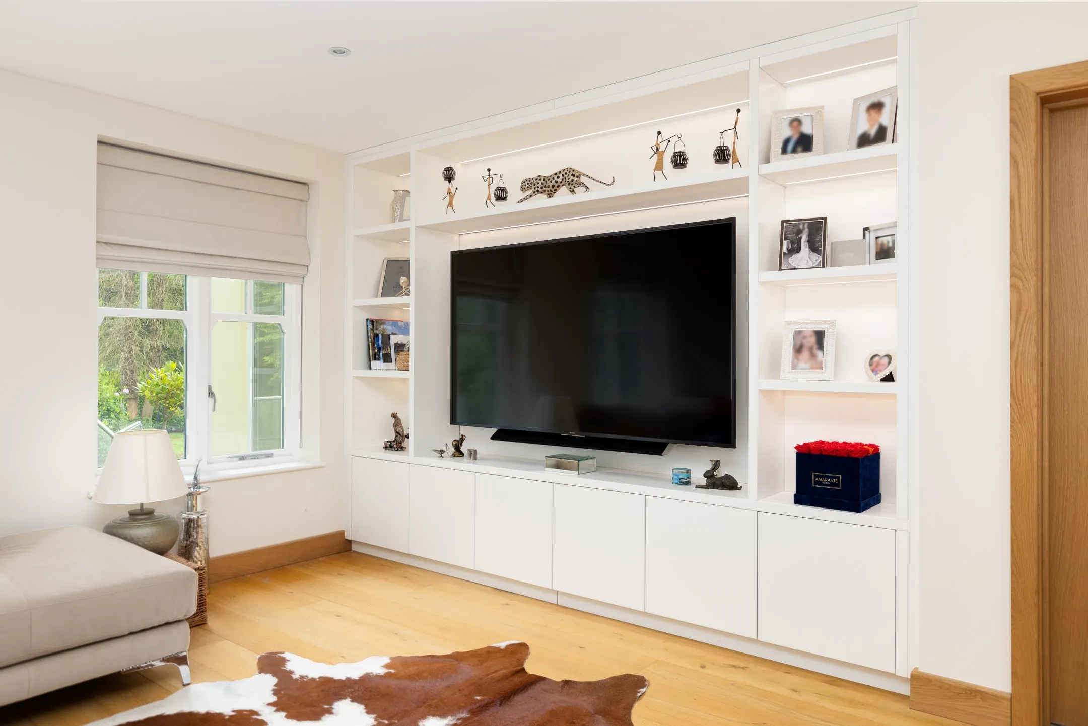 A living room with a couch and a flat screen tv.