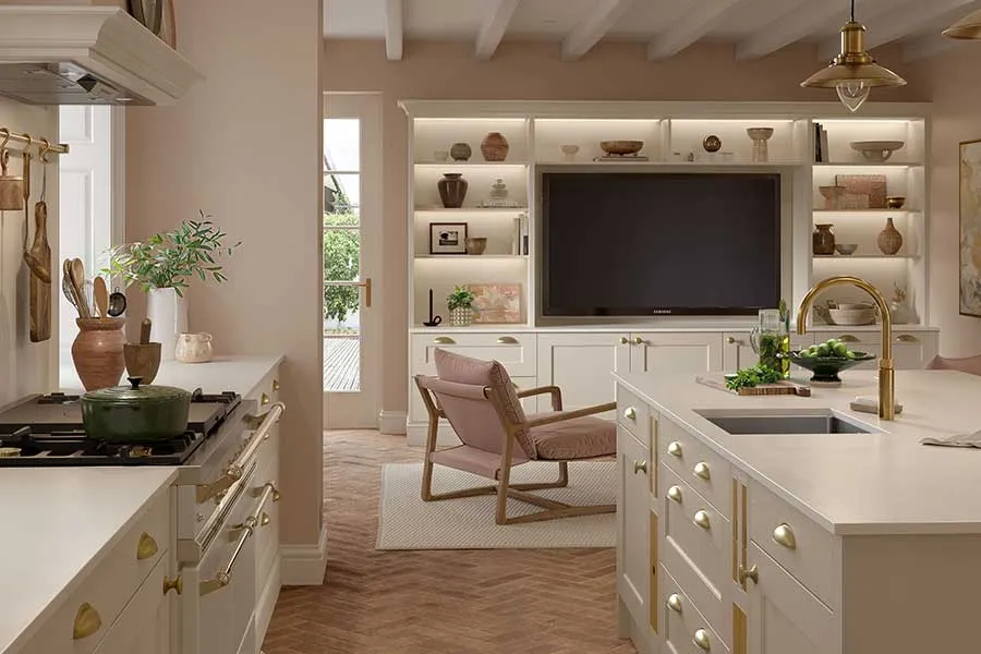 A kitchen with a large tv mounted on the wall.